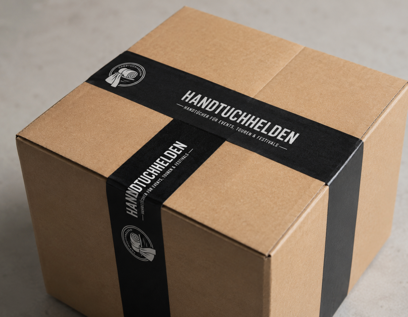 Zuverlässige Lieferung von Handtüchern Gestapelte Handtücher auf einem Tisch, im Hintergrund ein Transporter.